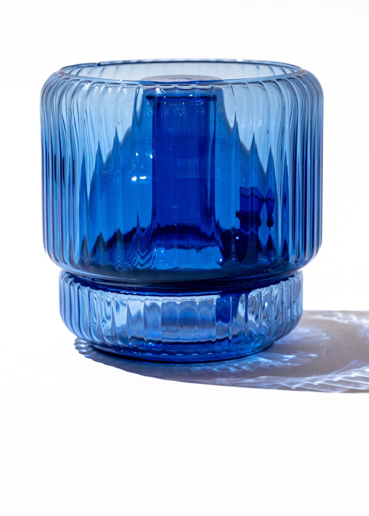Ribbed glass blue decorative vase bong on white background
