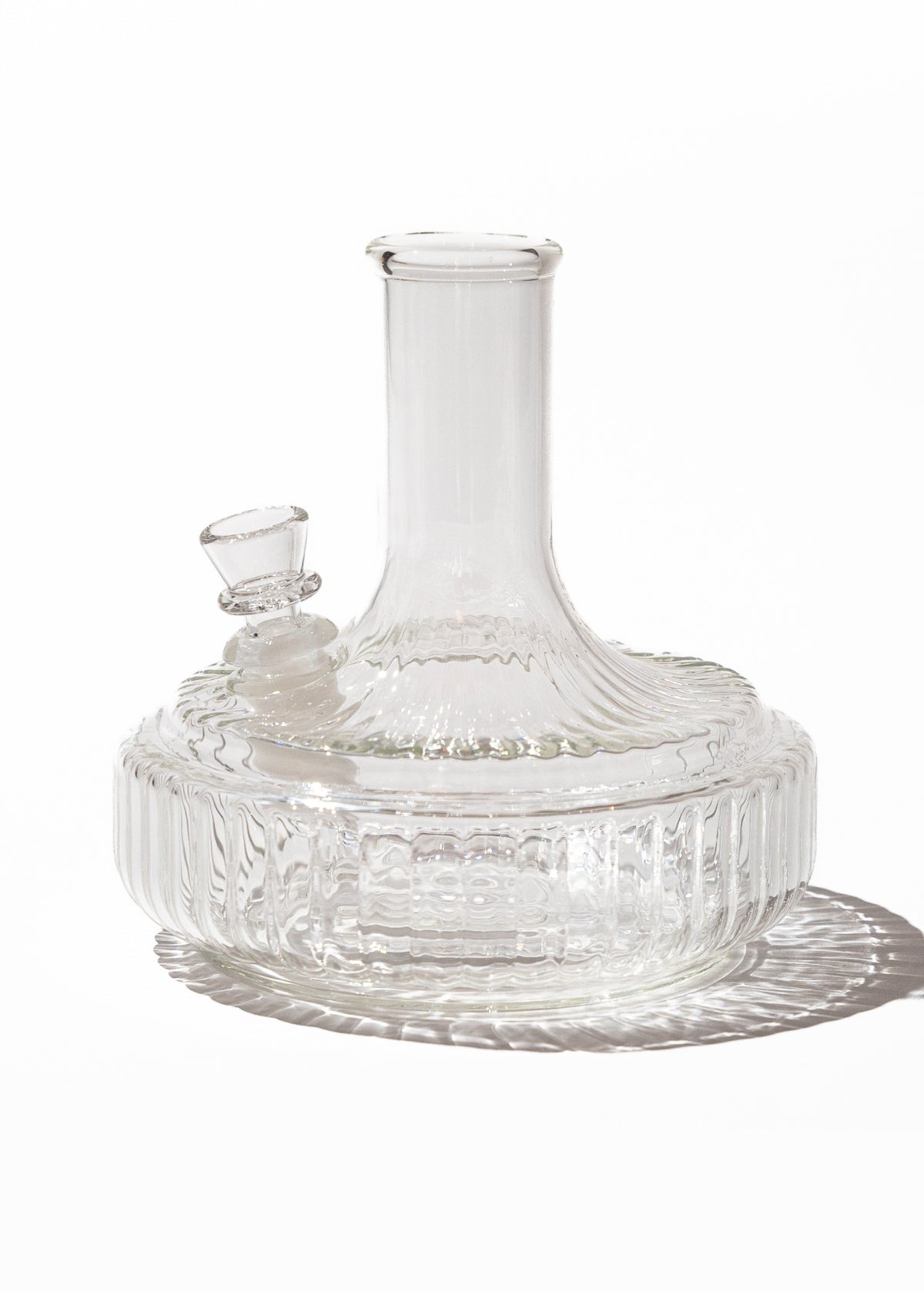 Clear ribbed glass bong with matching bowl piece on white background